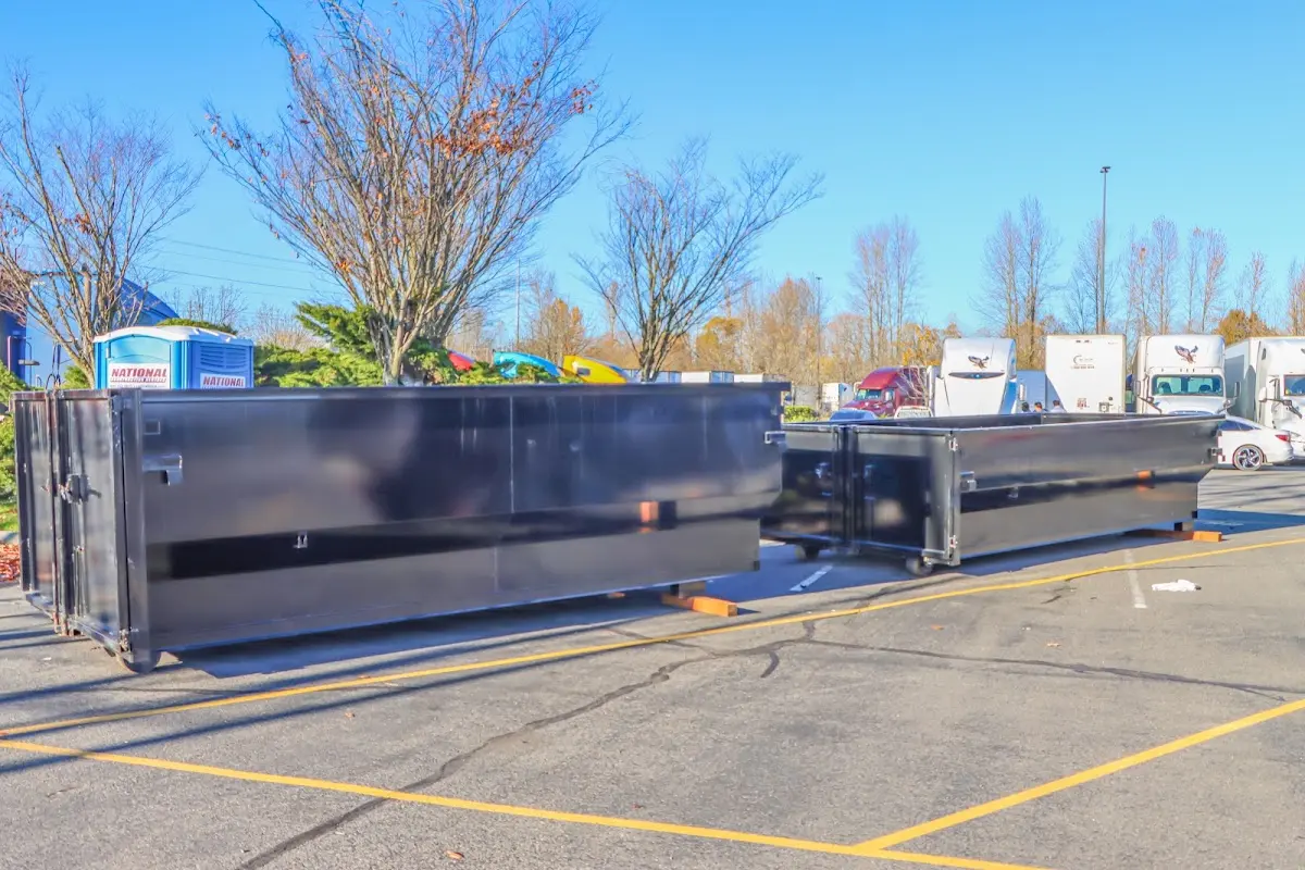 Professional dumpster rental service with roll-off container on residential driveway in Kinderhook